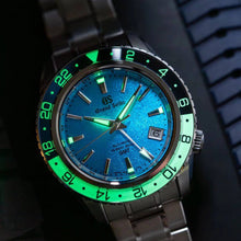 Grand Seiko SBGJ279 Yoshino River Harada Exclusive GMT watch, blue dial inspired by Yoshino River, indigo‑white bezel with lume. 