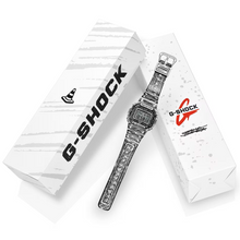 Casio G-Shock DW-5600JV-7 Joshua Vides limited edition watch with white resin case, bold black comic-style graphics, digital display, and matching custom packaging box featuring signature street art design.