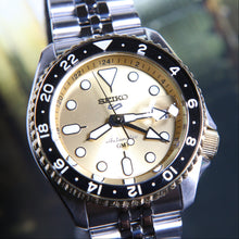 Macro close-up of Seiko 5 Sports SSK044 case, bezel and gold GMT dial, SKX-style finish, Taiwan 70th Anniversary limited 500