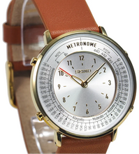 Seiko Metronome Watch SMW003A side view with golden case, silver dial, camel brown leather strap, dual‑function time and tempo display.