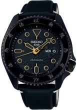 Seiko X Bruce Lee 5 Sports 55th Anniversary SKX Sense Style Limited Edition Watch, model SRPK39 SBSA239 SRPK39k1. Features black case and leather strap inspired by Bruce Lee's Kung Fu uniform, golden dragon motifs, additional yellow and black nylon strap, and dragon motif dial. Includes commemorative box and postcard. Limited to 5,000 pieces, with "Jeet Kune Do" core symbol on case back. Available now at Watchoutz.com: fast shipping, exceptional customer service, seamless shopping experience, and community