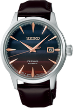 Seiko Presage Cocktail Time Series STARBAR 'Purple Sunset' Limited Edition Watch, model SRPK75 SRPK75J1 SARY239. Features a stunning purple dial inspired by the hues of a sunset cocktail, with a stainless steel case and bracelet. The watch includes elegant silver-tone hands and markers and a see-through case back. Limited edition model, perfect for collectors. Available at Watchoutz.com, enjoy fast and secure international shipping and enhance your seamless online horology shopping experience.