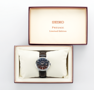 Seiko Presage Cocktail Time Series STARBAR 'Purple Sunset' Limited Edition Watch, model SRPK75 SRPK75J1 SARY239. Features a stunning purple dial inspired by the hues of a sunset cocktail, with a stainless steel case and bracelet. The watch includes elegant silver-tone hands and markers, and a see-through case back. Limited edition model, perfect for collectors and cocktail enthusiasts. Available now at Watchoutz.com: fast shipping, exceptional customer service, seamless shopping experience