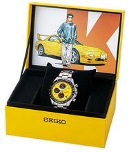 Unboxing view of the Seiko X Initial D Akagi RedSuns Keisuke Takahashi Yellow RX-7 FD3S 1995 Limited Edition Quartz Chronograph Watch in packaging box with artwork cover
